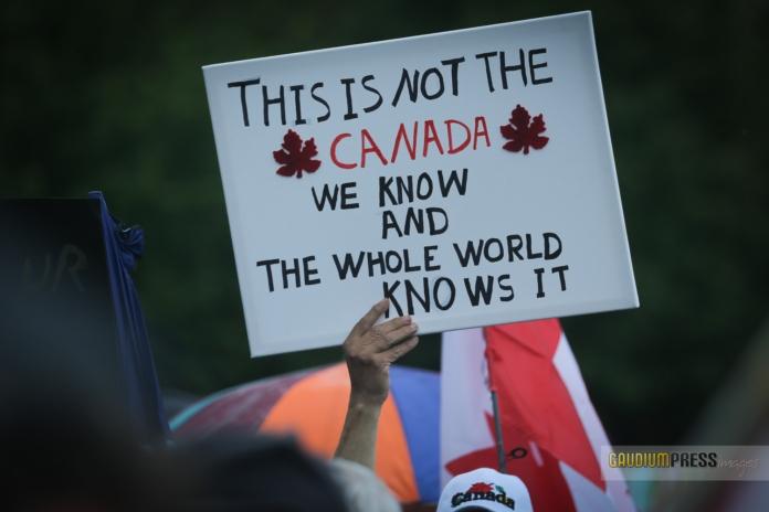 Protesters march agains the vandalizing of Churches in Canada